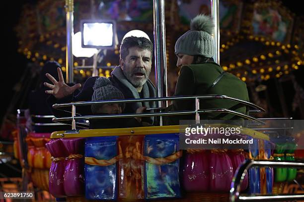 Simon Cowell, Eric Cowell and Lauren Silverman seen at Hyde Park Winter Wonderland on November 17, 2016 in London, England.