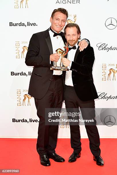 Oliver Masucci and Fabian Busch pose with award at the Bambi Awards 2016 winners board at Stage Theater on November 17, 2016 in Berlin, Germany.