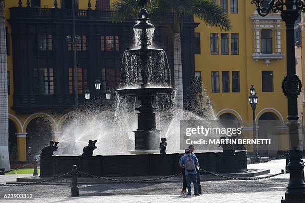 Locals enjoy the Plaza de Armas at Lima's historic centre, during the Asia-Pacific Economic Cooperation Summit on November 17, 2016. Top world...