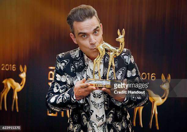 Robbie Williams poses with award at the Bambi Awards 2016 winners board at Stage Theater on November 17, 2016 in Berlin, Germany.