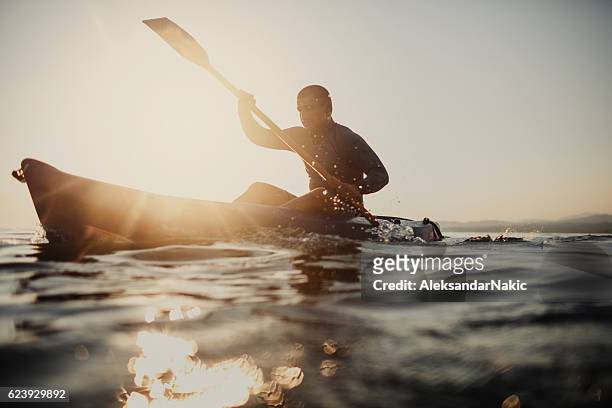 silhouette of a canoeist - kayak stock pictures, royalty-free photos & images
