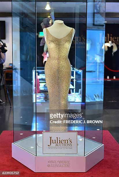 The dress worn by Marilyn Monroe when she sang "Happy Birthday Mr. President" to US President John F. Kennedy in May 1962, is displayed in a glass...