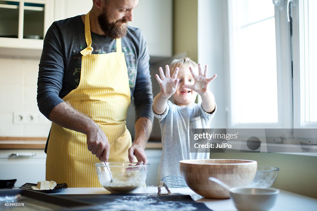 Father cooking with his son