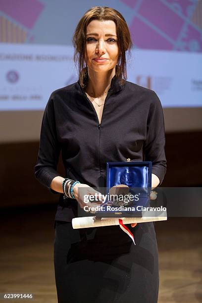 Writer Elif Shafak poses with the 'Sigillo of the city of Milan during the Bookcity Milan 2016 on November 17, 2016 in Milan, Italy.