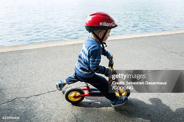 boy riding scooter - divertissement foto e immagini stock