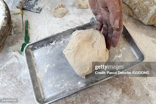 hands of baker preparing dough on wooden table - table nourriture stockfoto's en -beelden