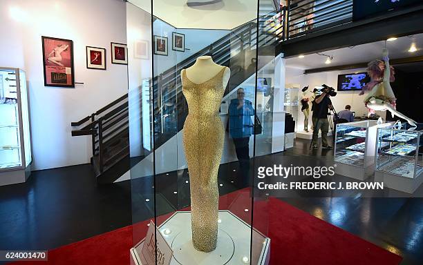 The dress worn by Marilyn Monroe when she sang "Happy Birthday Mr. President" to US President John F. Kennedy in May 1962 is on display in a glass...