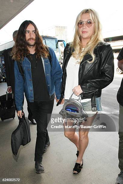Kesha and Brad Ashenfelter are seen at LAX on November 17, 2016 in Los Angeles, California.