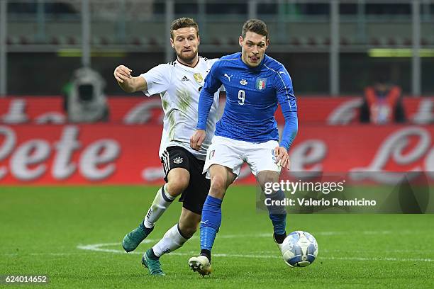 Andrea Belotti of Italy is challenged by Shkodran Mustafi of Germany during the International Friendly Match between Italy and Germany at Giuseppe...