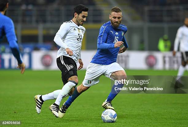 Daniele De Rossi of Italy competes with Ilkay Gundogan of Germany during the International Friendly Match between Italy and Germany at Giuseppe...