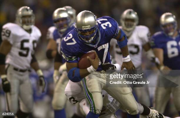 Shaun Alexander of the Seattle Seahawks outruns a tackle by the Oakland Raiders during the game at Husky Stadium in Seattle, Washington. The Seattle...