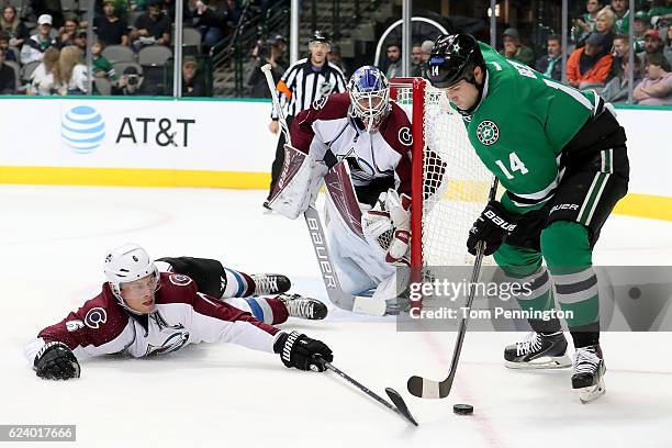 Jamie Benn of the Dallas Stars controls the puck against Erik Johnson of the Colorado Avalanche in the first period at American Airlines Center on...