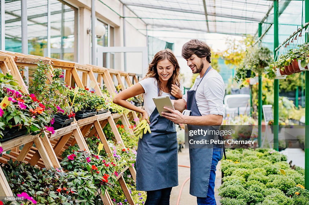 Couple of gardeners with digital tablet