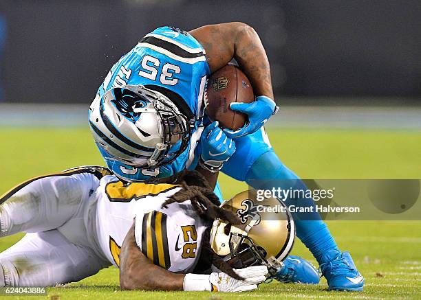 Mike Tolbert of the Carolina Panthers runs the ball against B.W. Webb of the New Orleans Saints in the third quarter during the game at Bank of...