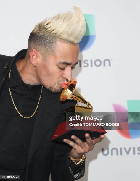 Motiff poses with the Grammy for Best Tropical Fusion Album during the 17th Annual Latin Grammy Awards on November 17 in Las Vegas, Nevada. / AFP...