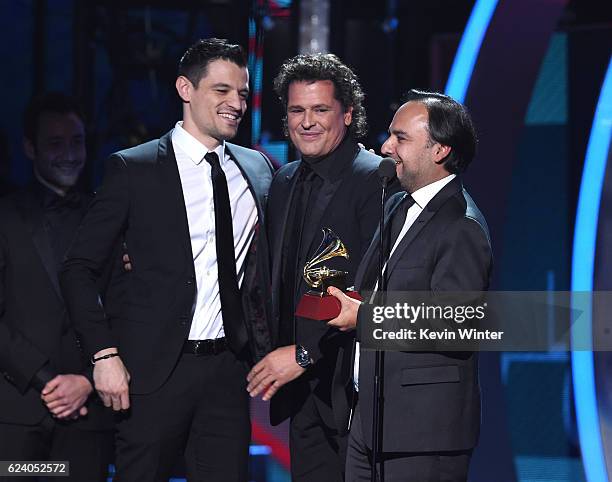 Audio engineer Luis Barrera Jr., singer/songwriter Carlos Vives and producer Andres Castro accept Song of the Year for 'La Bicicleta' onstage during...