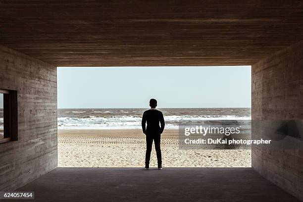 young man silhouette in beach - young man asian silhouette stock pictures, royalty-free photos & images