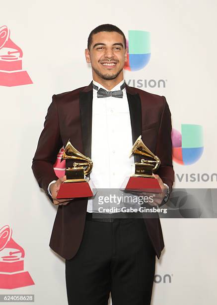 Recording artits Manuel Medrano poses with the Best Singer-Songwriter Album and Best New Artist awards in the press room during The 17th Annual Latin...