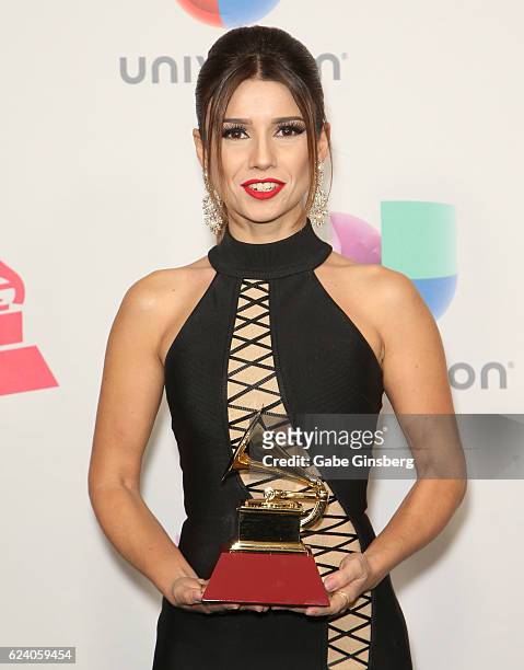 Recording artist Paula Fernandes poses with the Best Sertaneja Music Album award in the press room during The 17th Annual Latin Grammy Awards at...