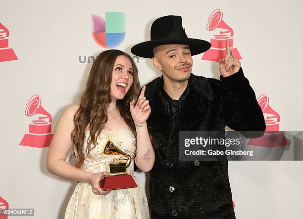 Recording artists Joy Huerta and Jesse Huerta of music group Jesse y Joy pose with the Best Contemporary Pop Vocal Album award in the press room...