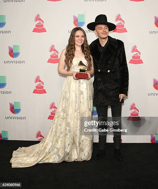 Recording artists Joy Huerta and Jesse Huerta of music group Jesse y Joy pose with the Best Contemporary Pop Vocal Album award in the press room...