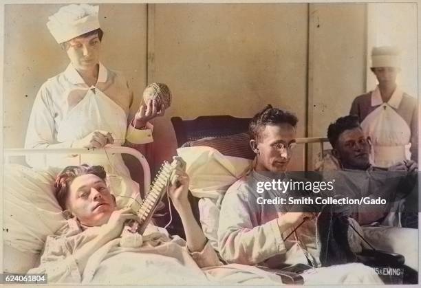 Three wounded soldiers knit from a hospital bed at Walter Reed Hospital, Washington, District of Columbia, 1917. Image courtesy National Archives....