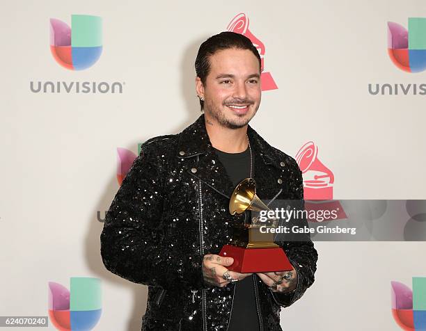 Recording artist J Balvin poses with the Best Urban Music Album award in the press room during The 17th Annual Latin Grammy Awards at T-Mobile Arena...