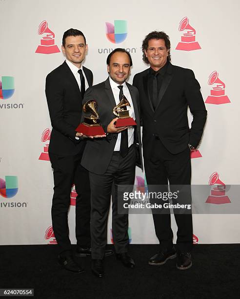 Record engineer/producer Luis Barrera Jr, composer Andres Castro and recording artist Carlos Vives pose with the Record Of The Year award in the...