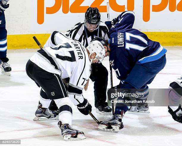 Jeff Carter of the Los Angeles Kings takes a first period face-off against Adam Lowry of the Winnipeg Jets at the MTS Centre on November 13, 2016 in...