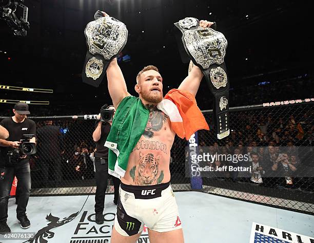 Lightweight and featherweight champion Conor McGregor of Ireland celebrates after defeating Eddie Alvarez in their UFC lightweight championship fight...