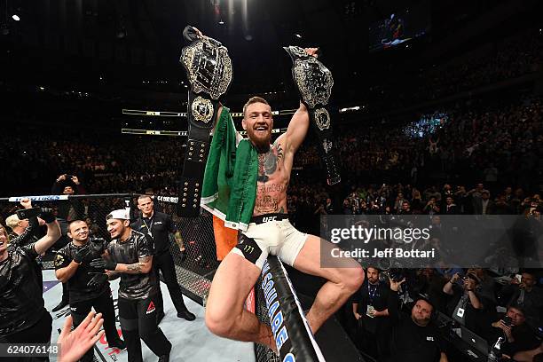 Lightweight and featherweight champion Conor McGregor of Ireland celebrates after defeating Eddie Alvarez in their UFC lightweight championship fight...