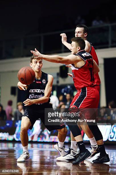 David Stockton of the Breakers makes a pass against Rotnei Clarke and AJ Ogilvy of the Hawks during the round seven NBL match between the New Zealand...