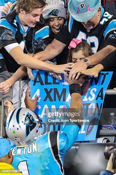 Carolina Panthers quarterback Cam Newton gives a ball to a little girl in the stands during the second half between the Carolina Panthers and the New...