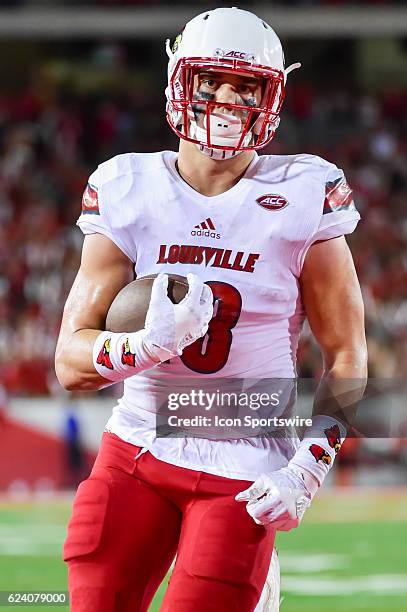 Louisville Cardinals tight end Cole Hikutini finds open field after a catch in the flat for a half touchdown during the NCAA football game between...