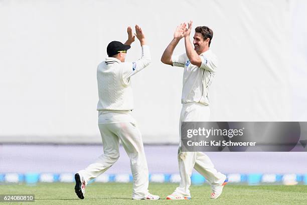 Colin de Grandhomme of New Zealand is congratulated by team mates after claiming his 5th wicket during day two of the First Test between New Zealand...