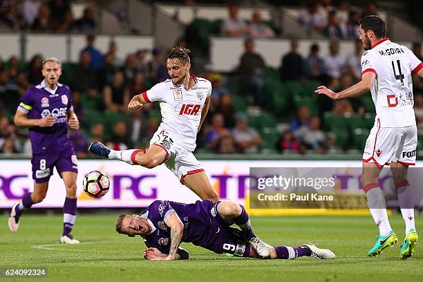 Andy Keogh of the Glory gets tackled by James Holland of Adelaide during the round seven A-League match between the Perth Glory and Adelaide United...