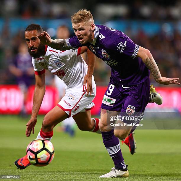Tarek Elrich of Adelaide and Andy Keogh of the Glory contest for the ball during the round seven A-League match between the Perth Glory and Adelaide...