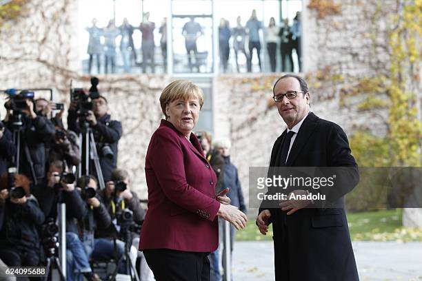 German Chancellor Angela Merkel welcomes French President Francois Hollande prior to meeting with EU leaders and the US President Barack Obama at the...