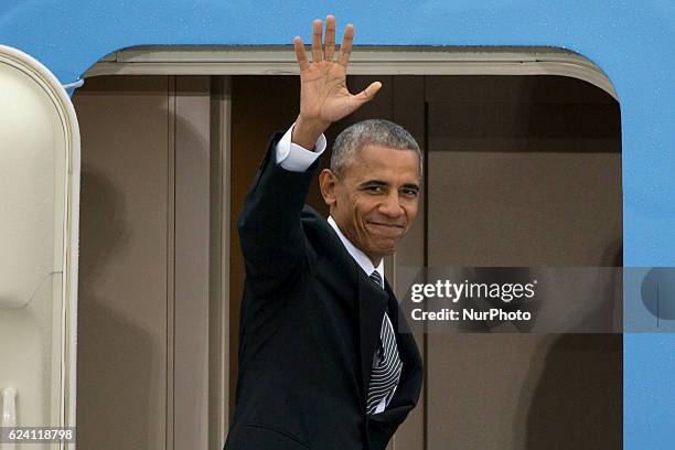 President Barack Obama waves as he boards the Air Force one at Tegel airport in Berlin, Germany on November 18, 2016.