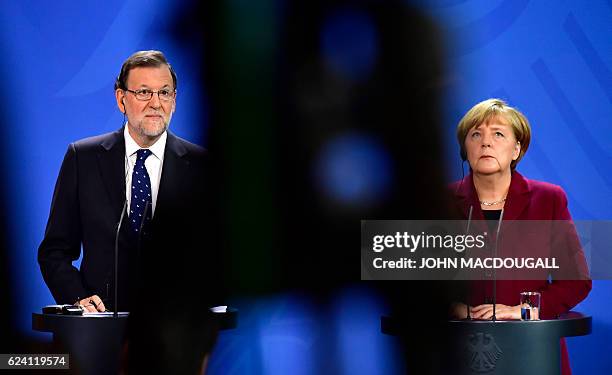 German Chancellor Angela Merkel and Spanish Prime minister Mariano Rajoy attend a press conference after teh meeting between the US President and...