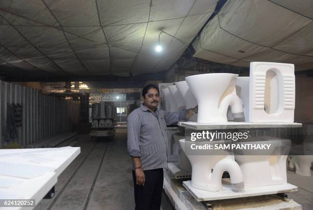 Kirit Patel, president of Morbi Sanitary Industries, poses next to ready to dispatch newly built toilets in the stockyard of a factory in Morbi, some...