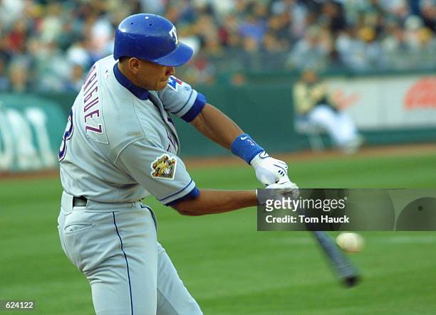Alex Rodriguez of the Texas Rangers hits the ball against the Oakland A's at the Network Associates Coliseum in Oakland, California. DIGITAL IMAGE...