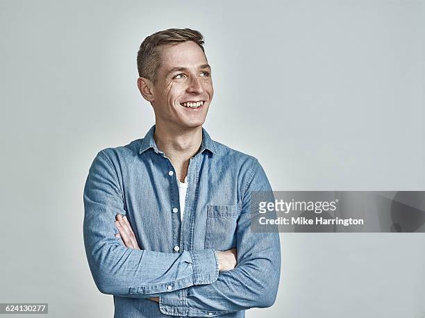 portrait of freckled european male, arms crossed - looking away stock pictures, royalty-free photos & images