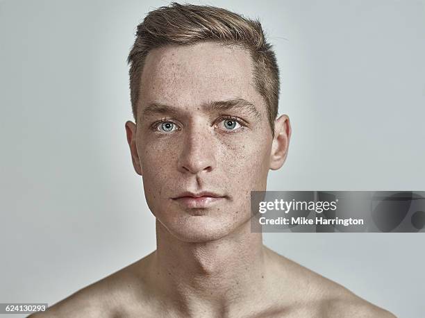 close up portrait of young freckled male - portrait concentration stock pictures, royalty-free photos & images