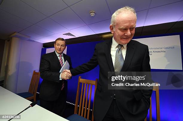 Northern Ireland Deputy First Minister Martin McGuinness shakes hands with Irish Taoiseach Enda Kenny after holding a press conference at the North...