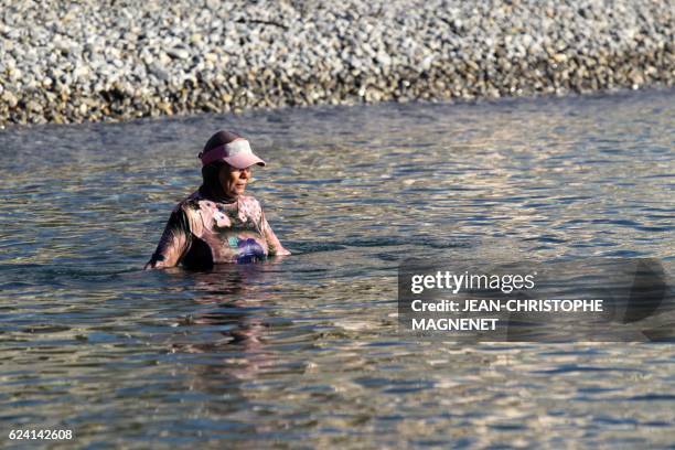 French woman named Dalila wears a burkini as she swims and sunbathes, on the beach of Carras, in the city of Nice, southeastern France, on August 26,...