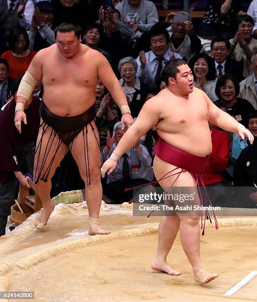 Endo reacts after beating Mongolian yokozuna Hakuho out of the ring to win during day six of the Grand Sumo Kyushu Tournament at Fukuoka Convention...