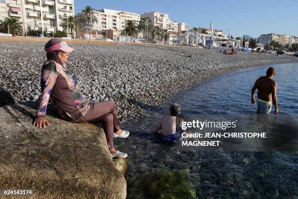 French woman named Dalila wears a burkini, as she sunbathes, on the beach of Carras, in the city of Nice, southeastern France, on August 26, 2016. -...