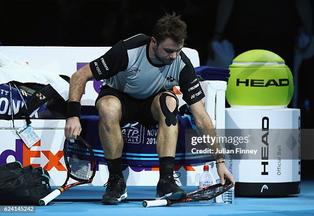 Stan Wawrinka of Switzerland breaks his racket in his men's singles match against Andy Murray of Great Britain on day six of the ATP World Tour...