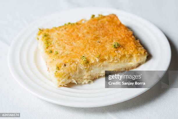 kunafa served on a plate on a white background - kunafa stockfoto's en -beelden